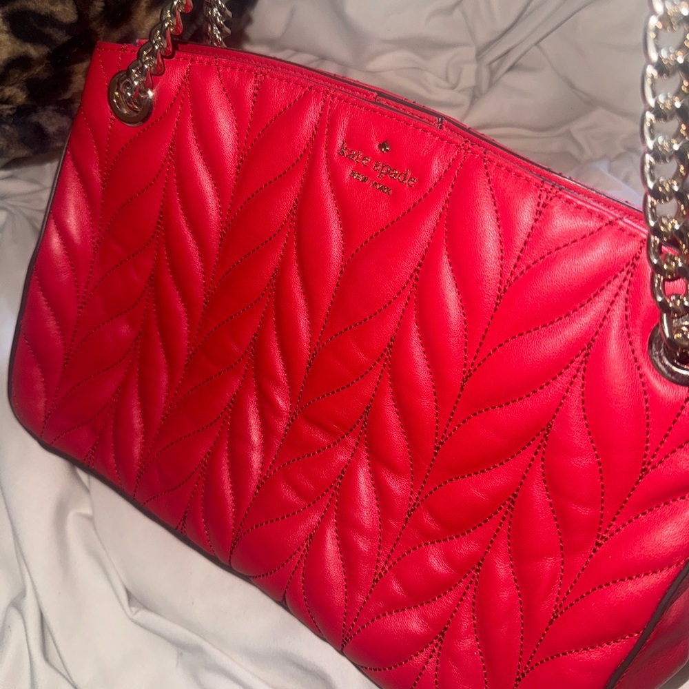 Red quilted limited edition Kate Spade purse with gold chains handles.